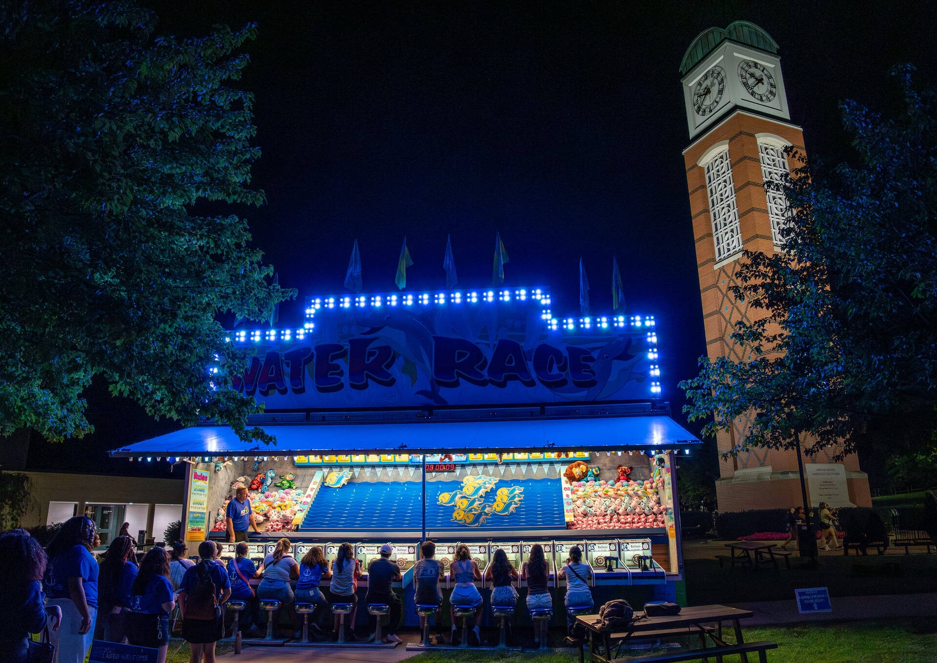 carnival game, water race, set up at night near cook carillon tower